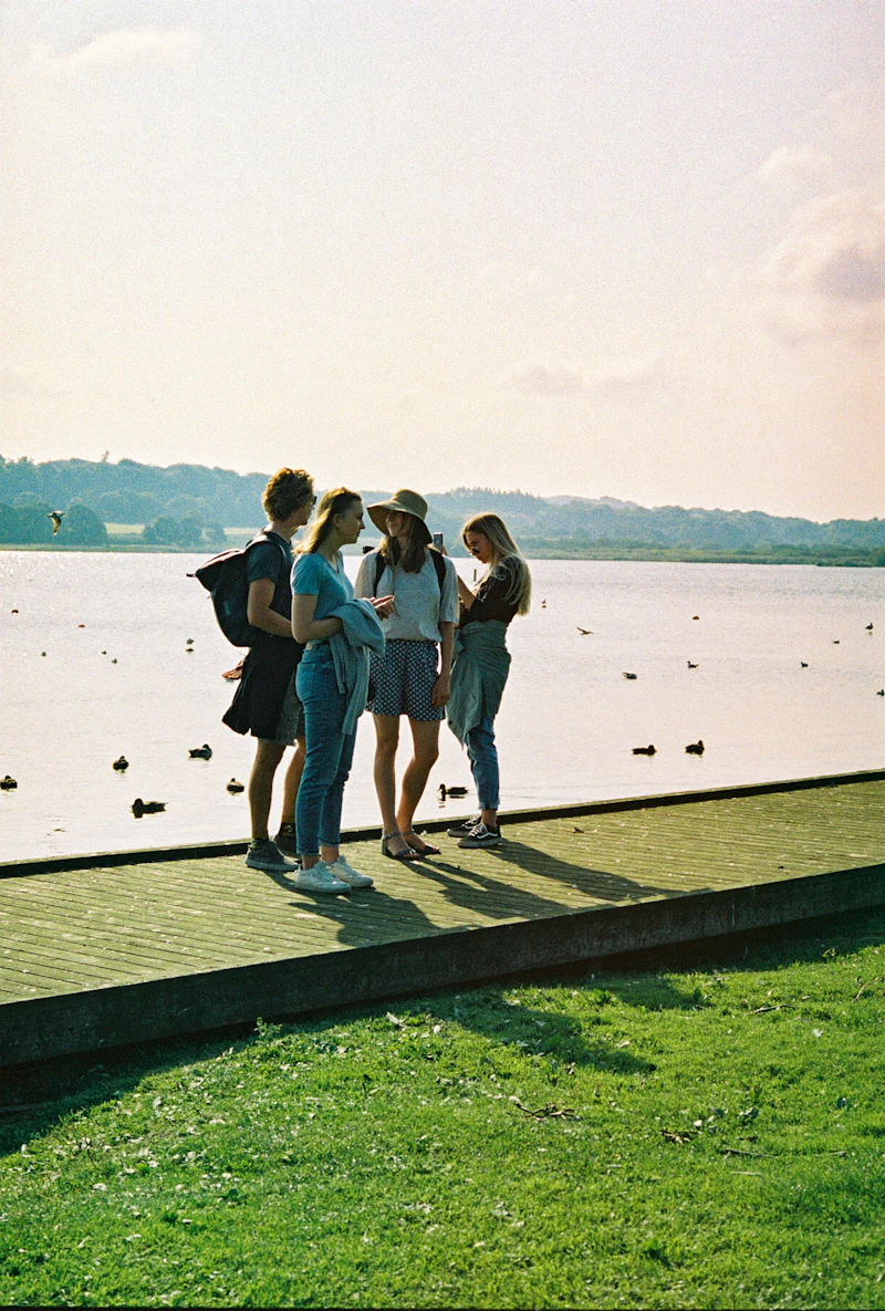 Three friends standing together on a sunny dock