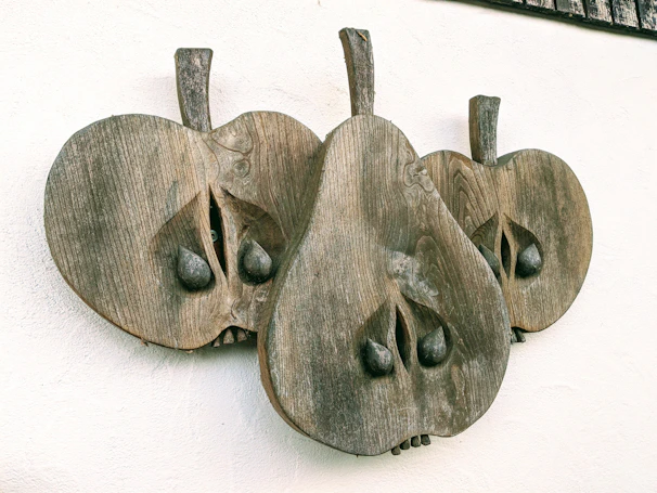 Wooden 3D wall sticker shaped like abstract leaves on a light-colored wall