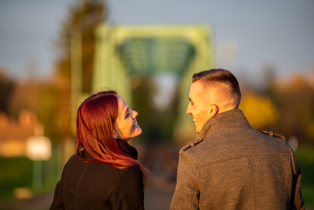 man and woman standing side by side during daytime