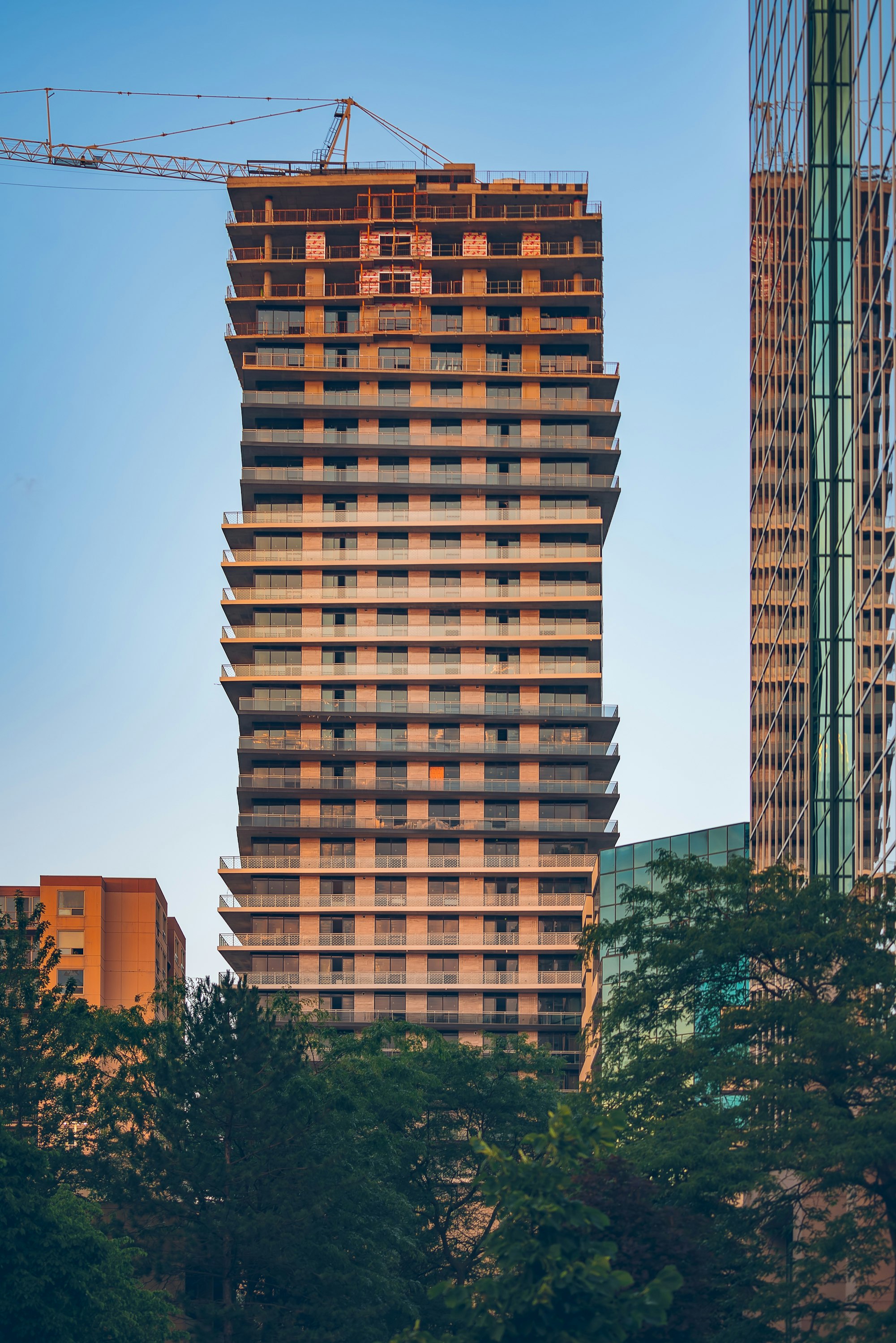 brown concrete building near green trees during daytime