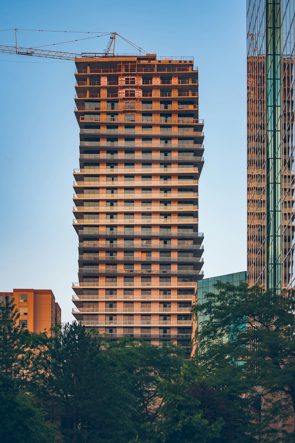 brown concrete building near green trees during daytime