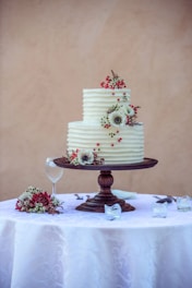 white and pink floral cake on white table