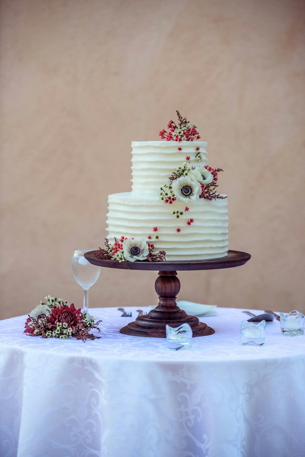 white and pink floral cake on white table