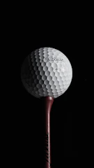 Close-up of a golf ball on the simulator tee ready for a swing.