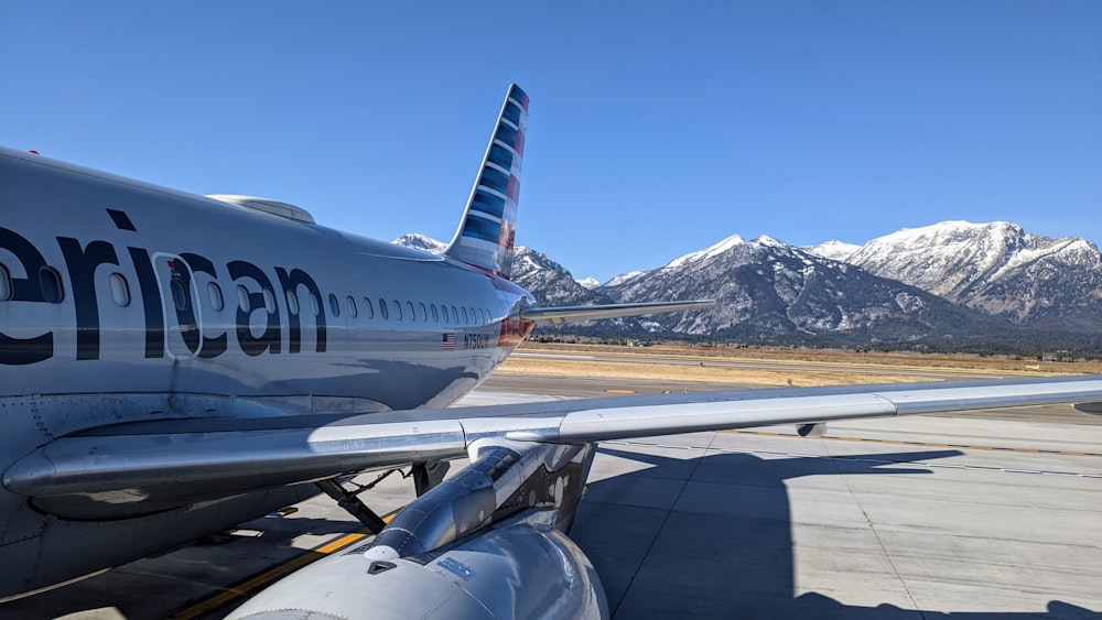 white and blue airplane on airport during daytime