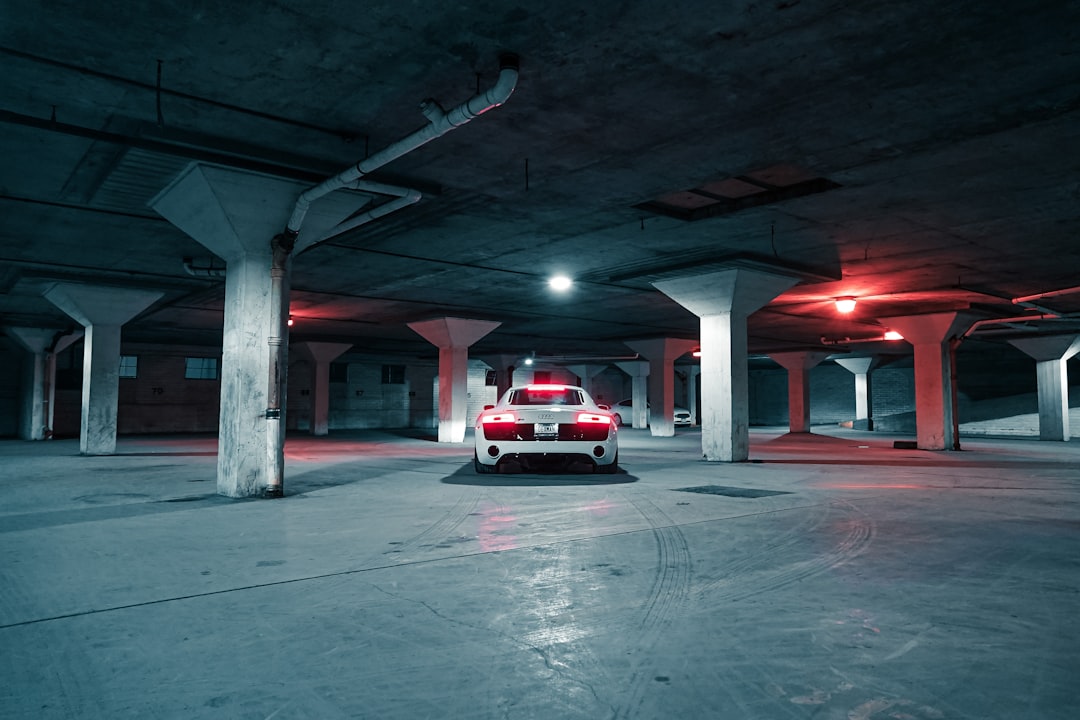 red and white car in a parking lot,