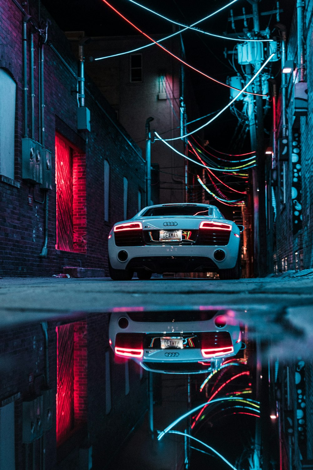 white car parked beside building