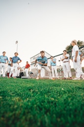 group of people standing on green grass field during daytime