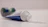 Close-up of a man holding a tube of toothpaste with a bright smile.