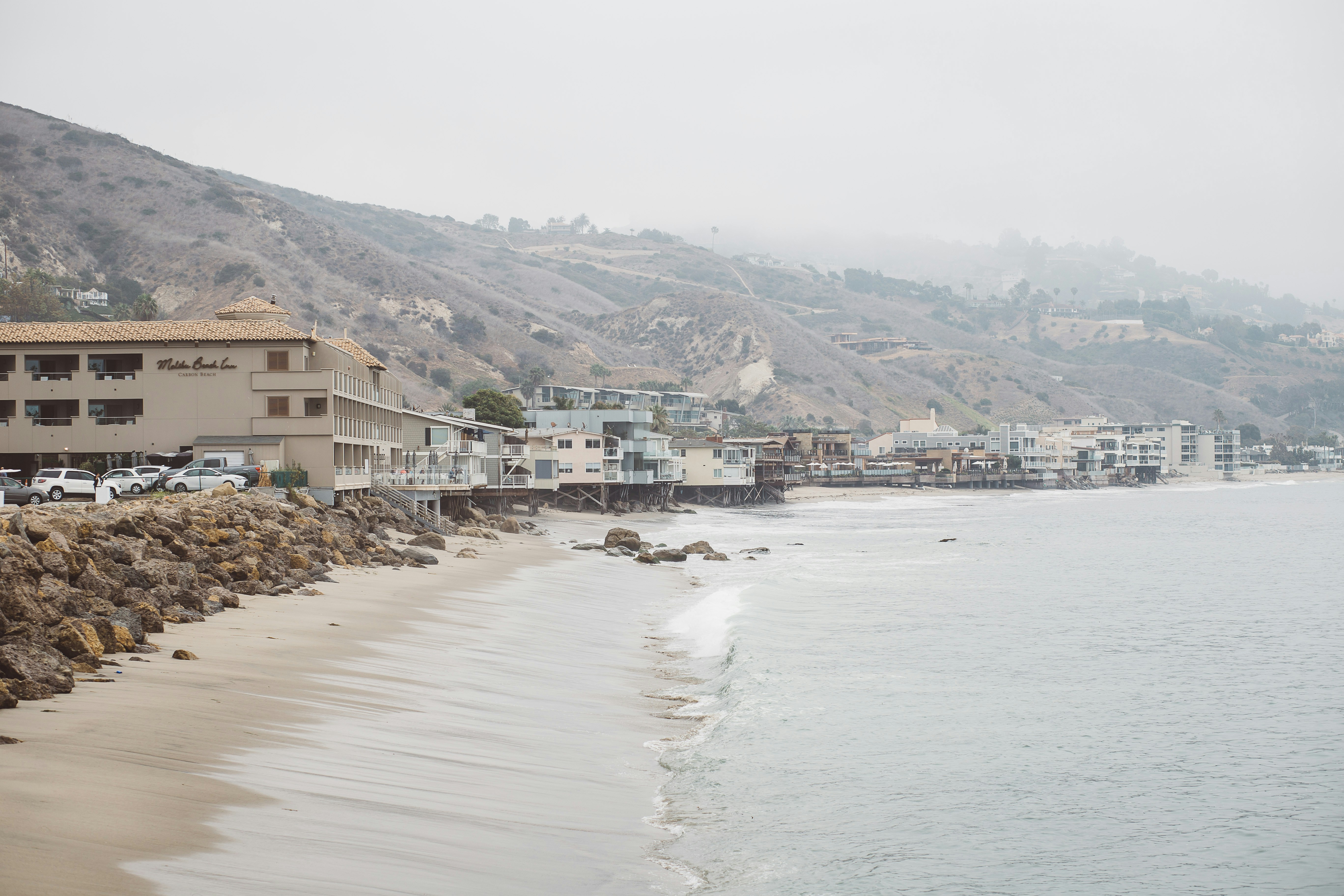 brown and white concrete buildings near body of water during daytime, Malibu Beach Breakfast Time