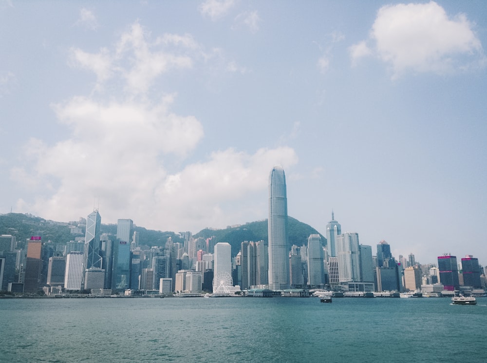 city skyline across body of water during daytime