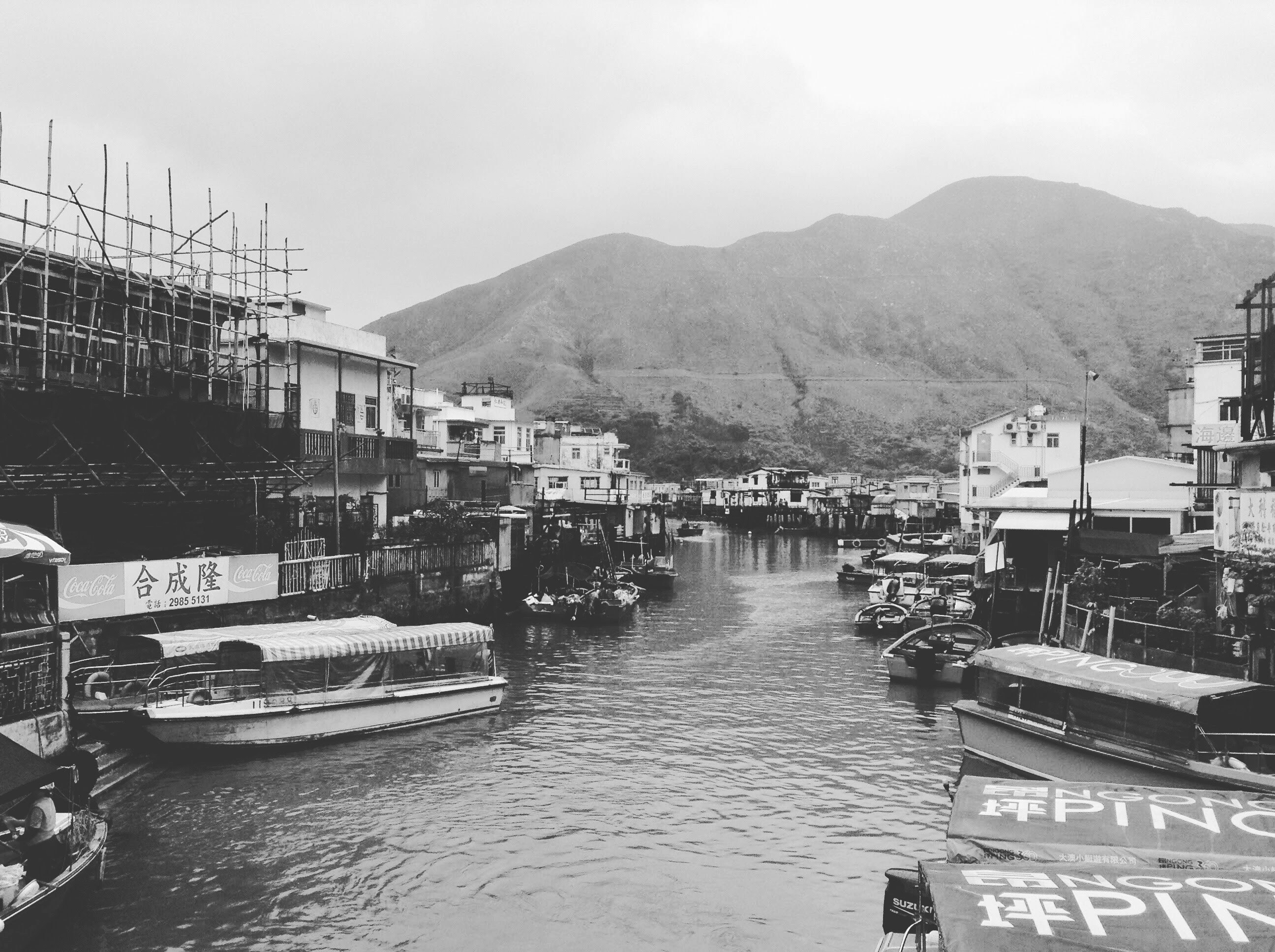 grayscale photo of boat on dock