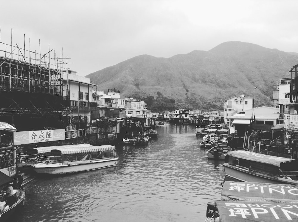 grayscale photo of boat on dock