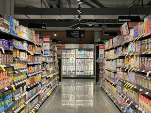 grocery store aisle with stocked shelves