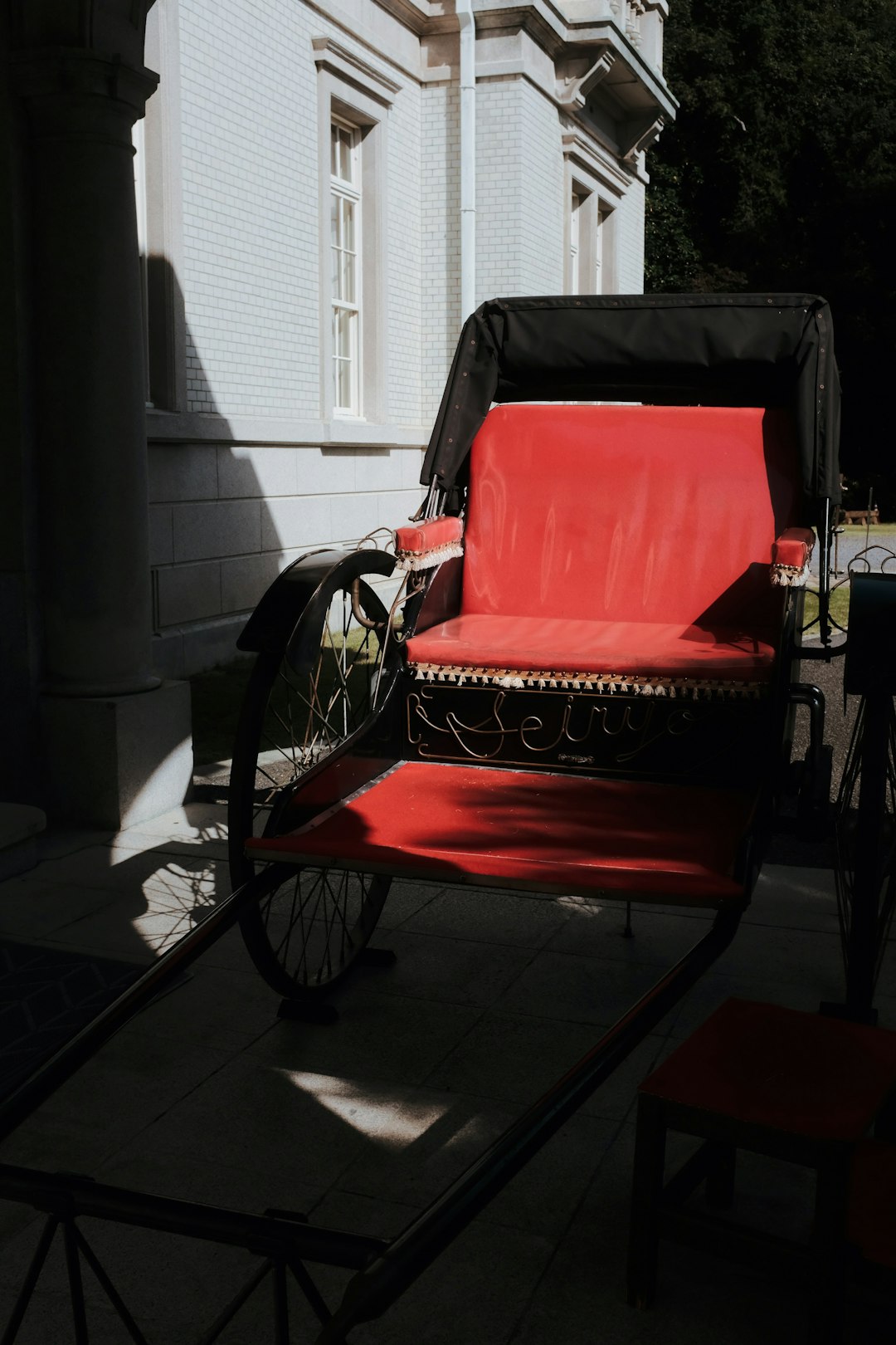 red and black wheelchair near white window blinds