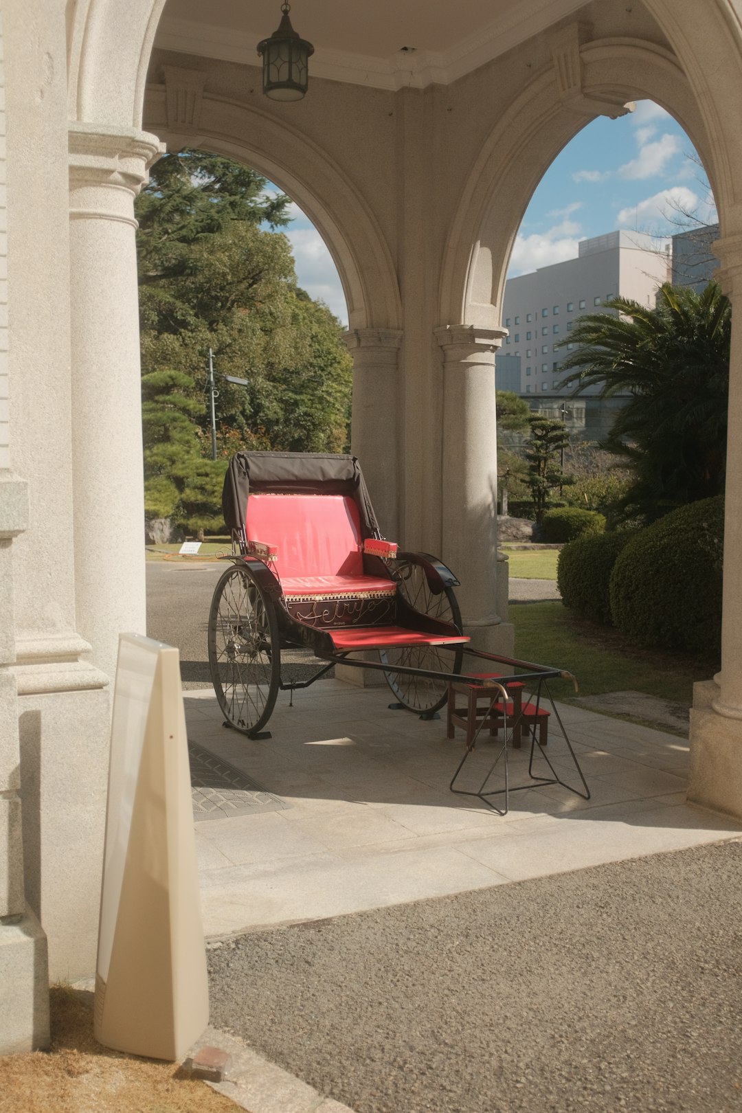 red and black wooden carriage near green trees during daytime