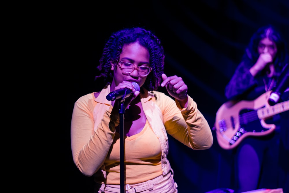 woman in white long sleeve shirt singing