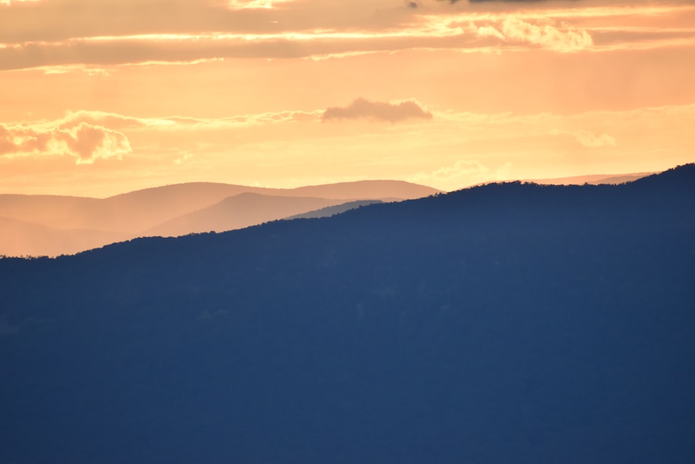 silhouette of mountains during sunset