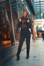 A model wearing a sleek horix outfit walking confidently through a city street.