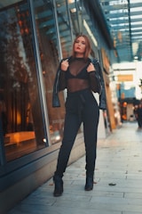 A sleek urban outfit displayed on a model walking through a bustling city street.