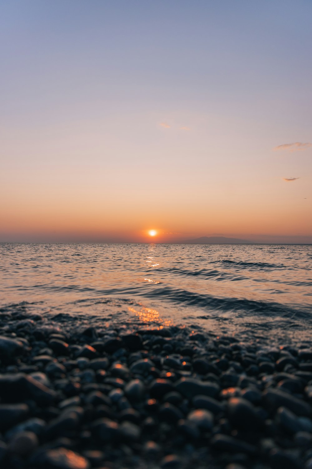 body of water during sunset