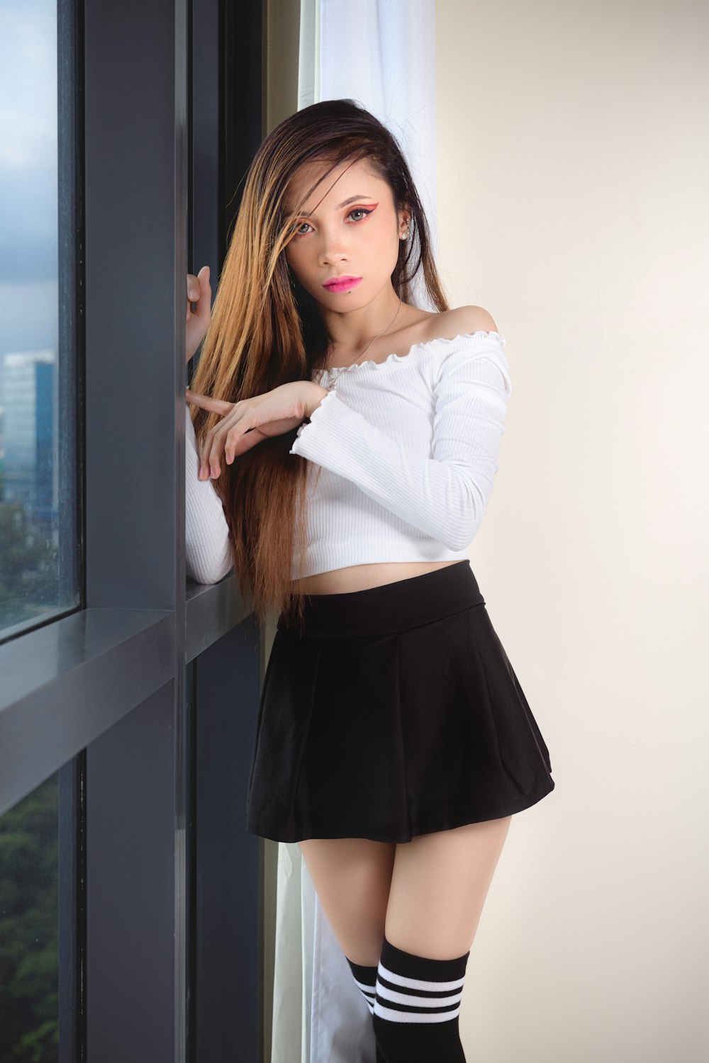 woman in white long sleeve shirt and black skirt