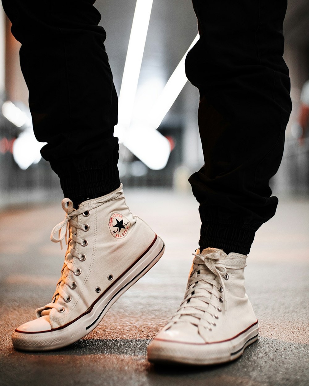 person in black pants wearing white converse all star high top sneakers  photo – Free Style Image on Unsplash
