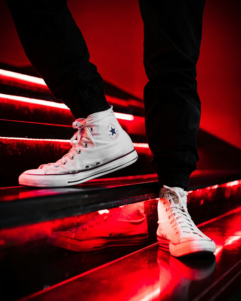 person in black pants wearing white converse all star high top sneakers  photo – Free Dubai - united arab emirates Image on Unsplash