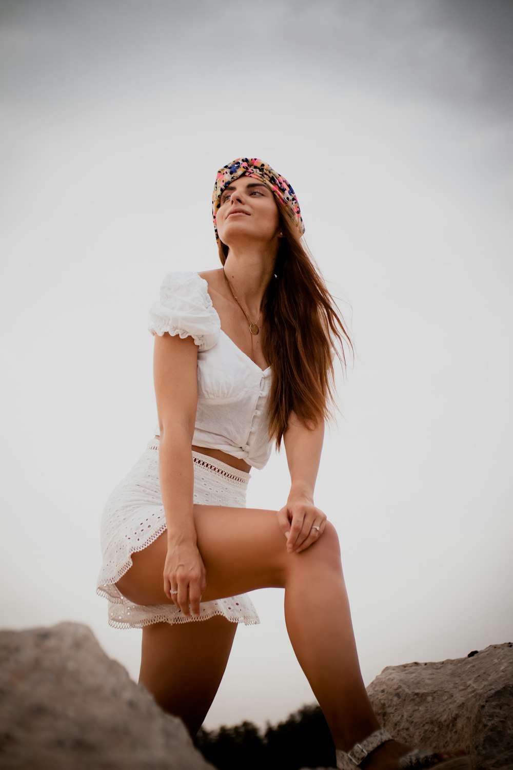 woman in white dress sitting on white floor