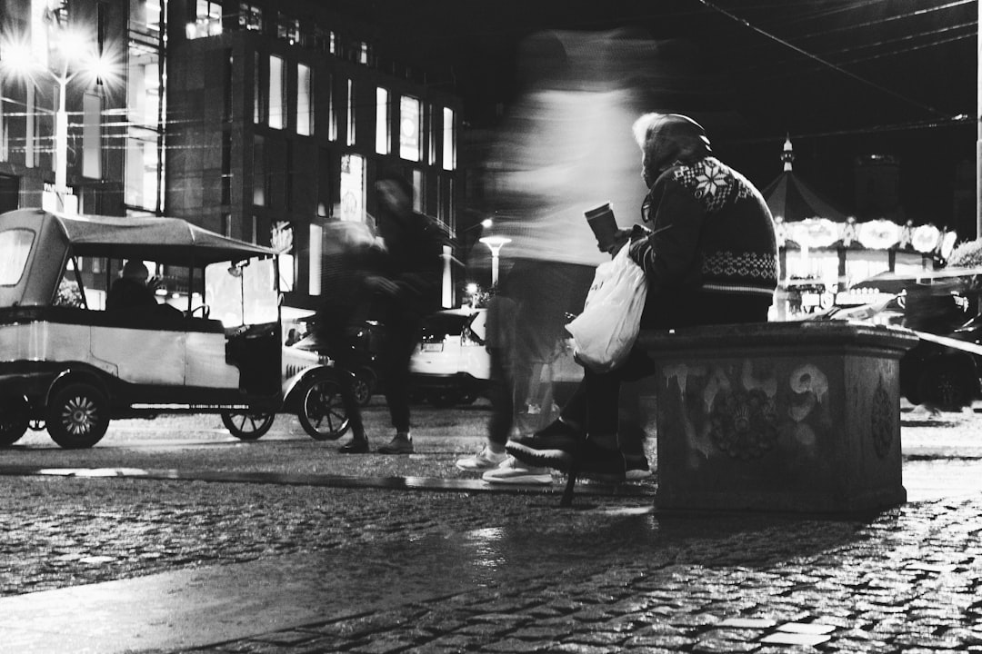 man in black jacket sitting on black chair