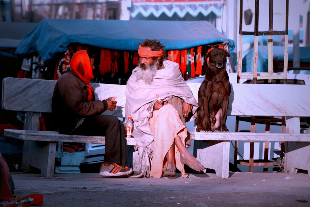 woman in pink long sleeve dress sitting on bench beside brown short coated dog