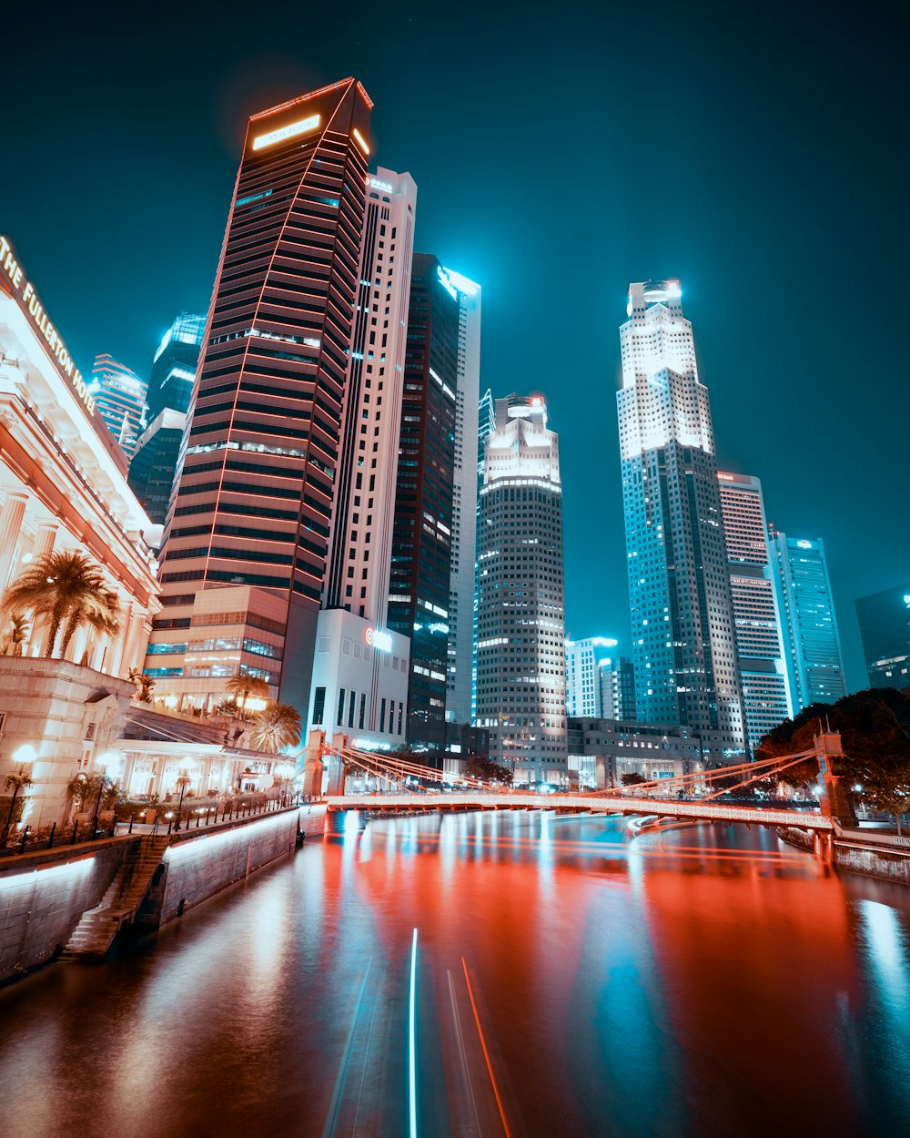 city buildings near body of water during night time