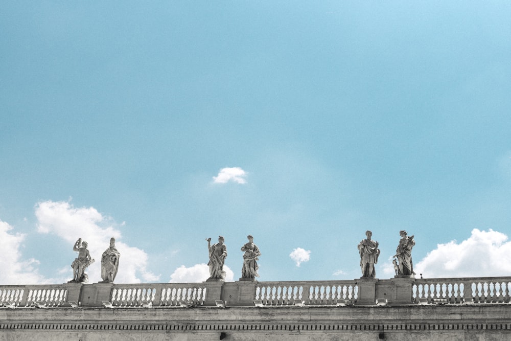 statue of man and woman on top of building