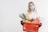woman in white long sleeve shirt holding red plastic basket with fruits