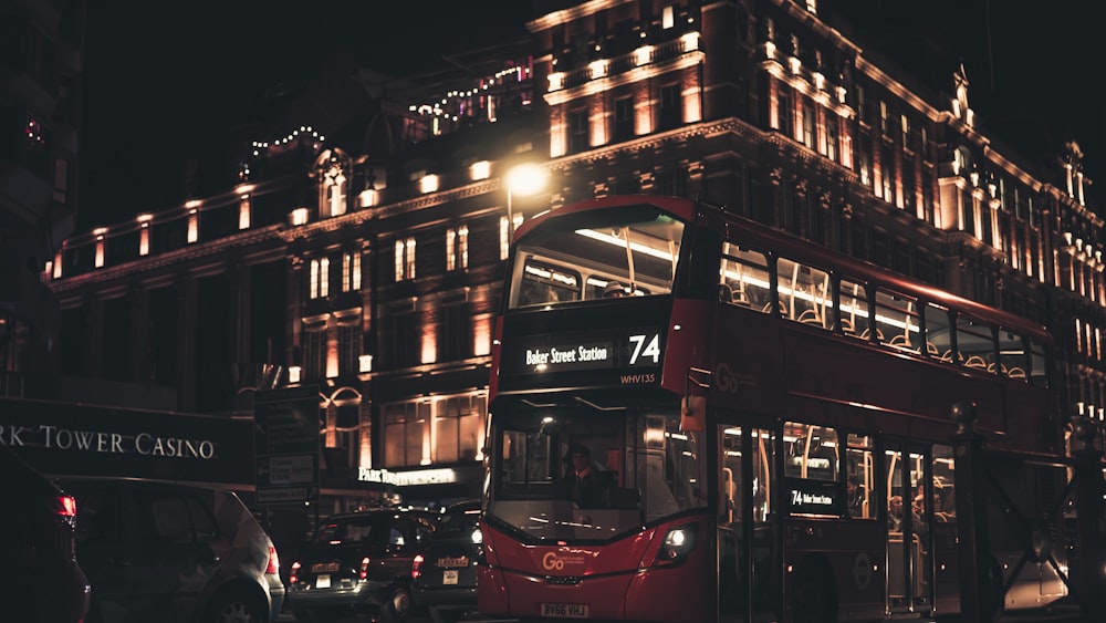 red double decker bus on road during night time