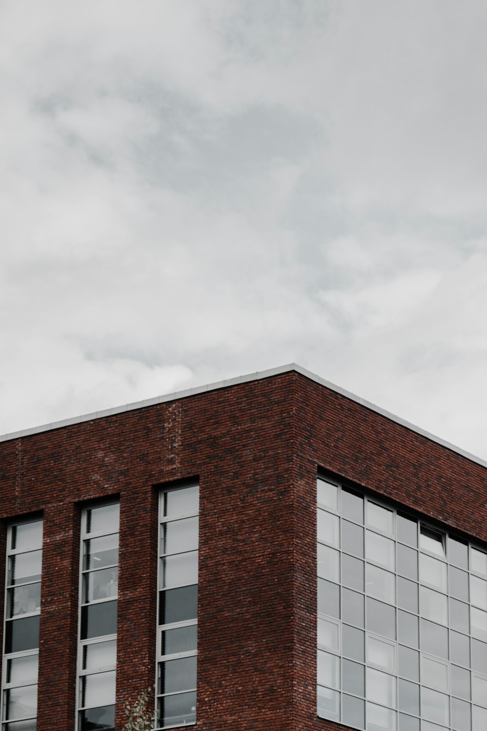 brown concrete building under white clouds during daytime