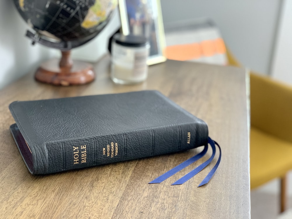 black book on brown wooden table