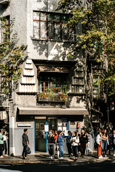 Hospital Clínic de Barcelona building with researchers walking outside on a sunny day.