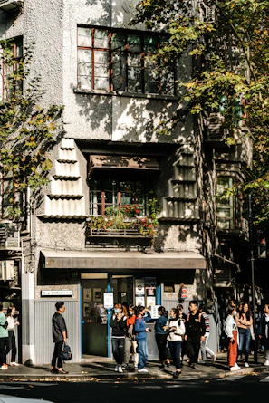 A group photo of happy clients standing outside the law office on a sunny day.