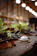 A serene cup of steaming herbal tea beside a small bamboo plant on a wooden table.
