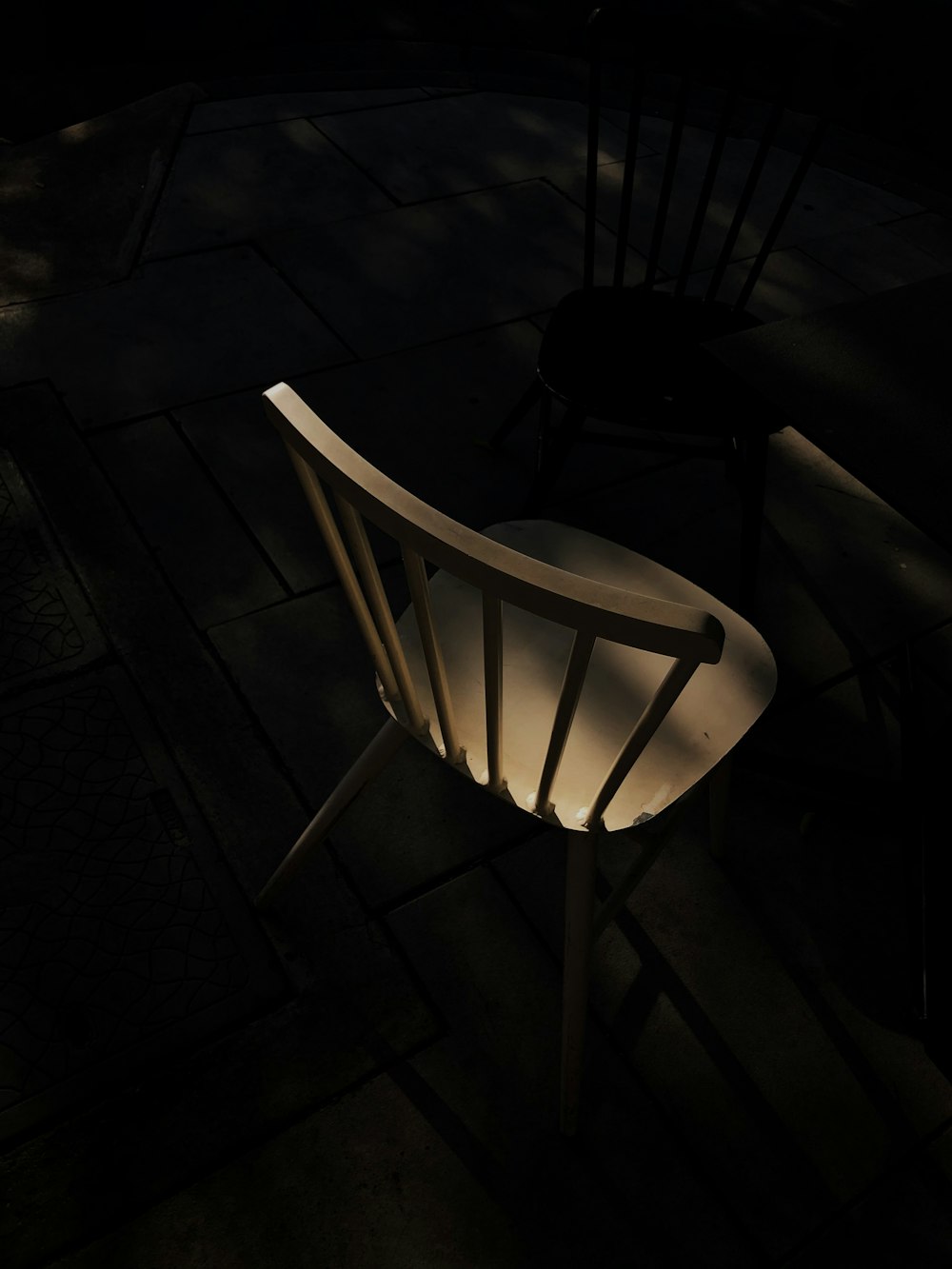 white wooden chair on black floor