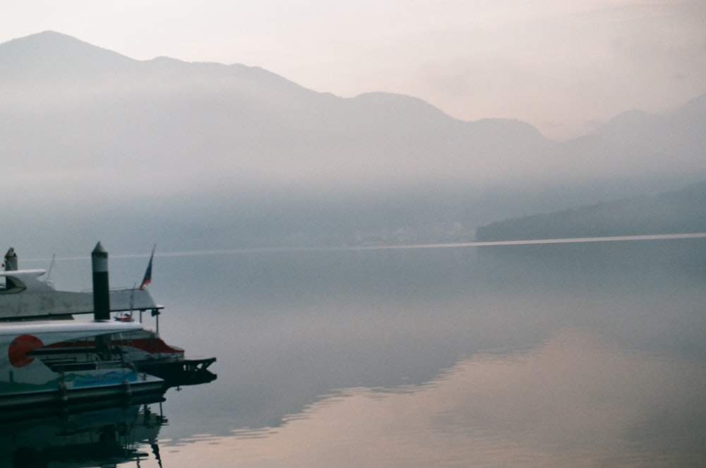 green and white boat on body of water during daytime