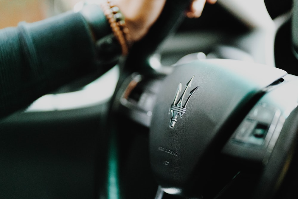 black and silver nissan car steering wheel