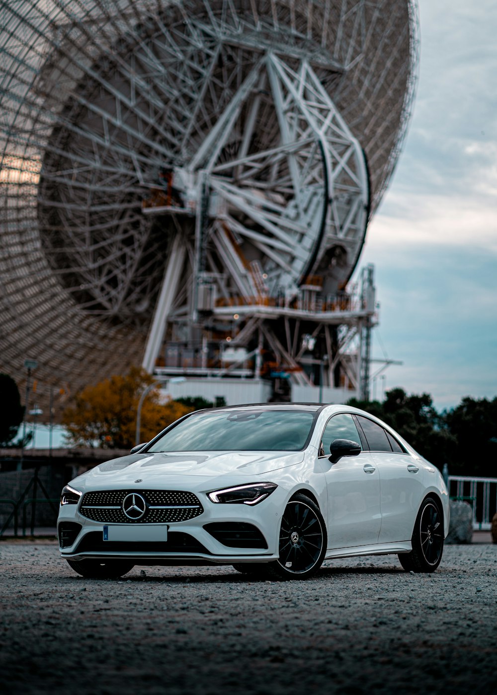 white mercedes benz coupe parked near ferris wheel during daytime