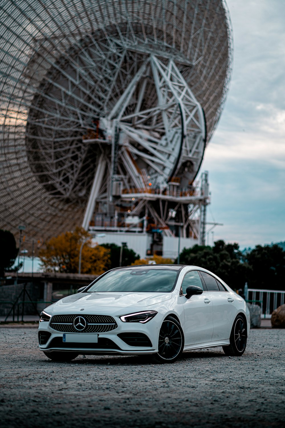 white mercedes benz coupe parked near ferris wheel during daytime