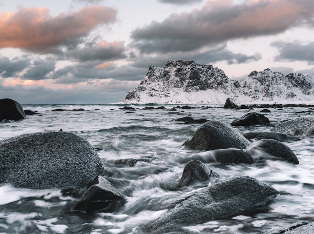 rocky shore under cloudy sky during daytime