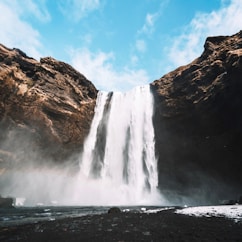 waterfalls under blue sky during daytime