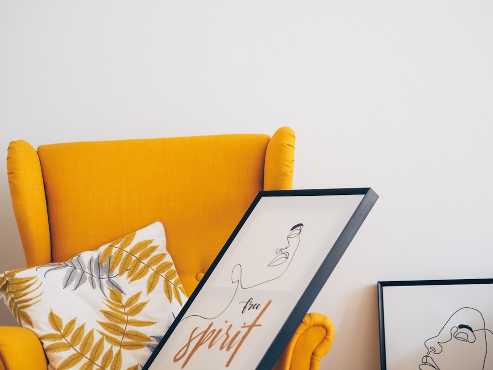 black framed white board on yellow couch