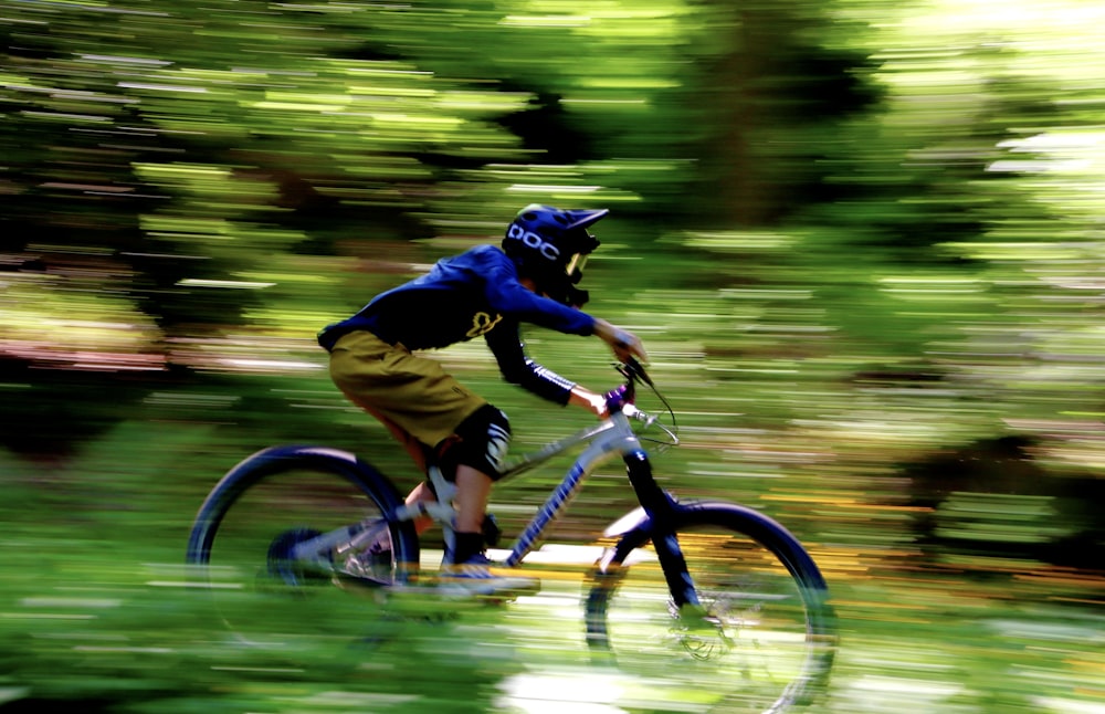 man in brown jacket riding on bicycle