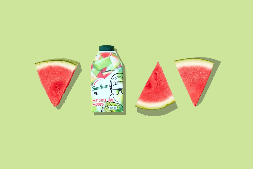 green and white labeled bottle beside sliced watermelon